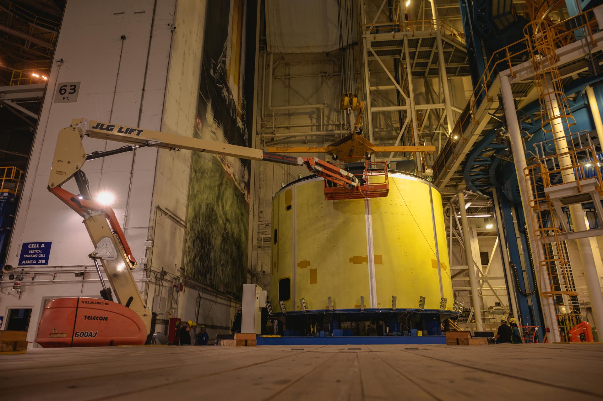 Teams at Michoud Assembly Facility in New Orleans load the engine section barrel into the vertical assembly center on Aug. 5, 2026. The engine section will be used on the SLS (Space Launch System) rocket’s core stage for the agency’s Artemis V mission. On the vertical assembly center tooling, teams will mate the flight hardware to a ring, which will serve as an attachment point for the liquid hydrogen tank later in the production process. The engine section is one of five major elements that make up the 212-foot-tall SLS rocket stage; and houses various avionic systems, the engine thrust structure, and four RS-25 engines. The core stage produces more than two million pounds of thrust to help launch NASA’s Orion spacecraft, astronauts, and supplies beyond Earth’s orbit and to the lunar surface for Artemis.